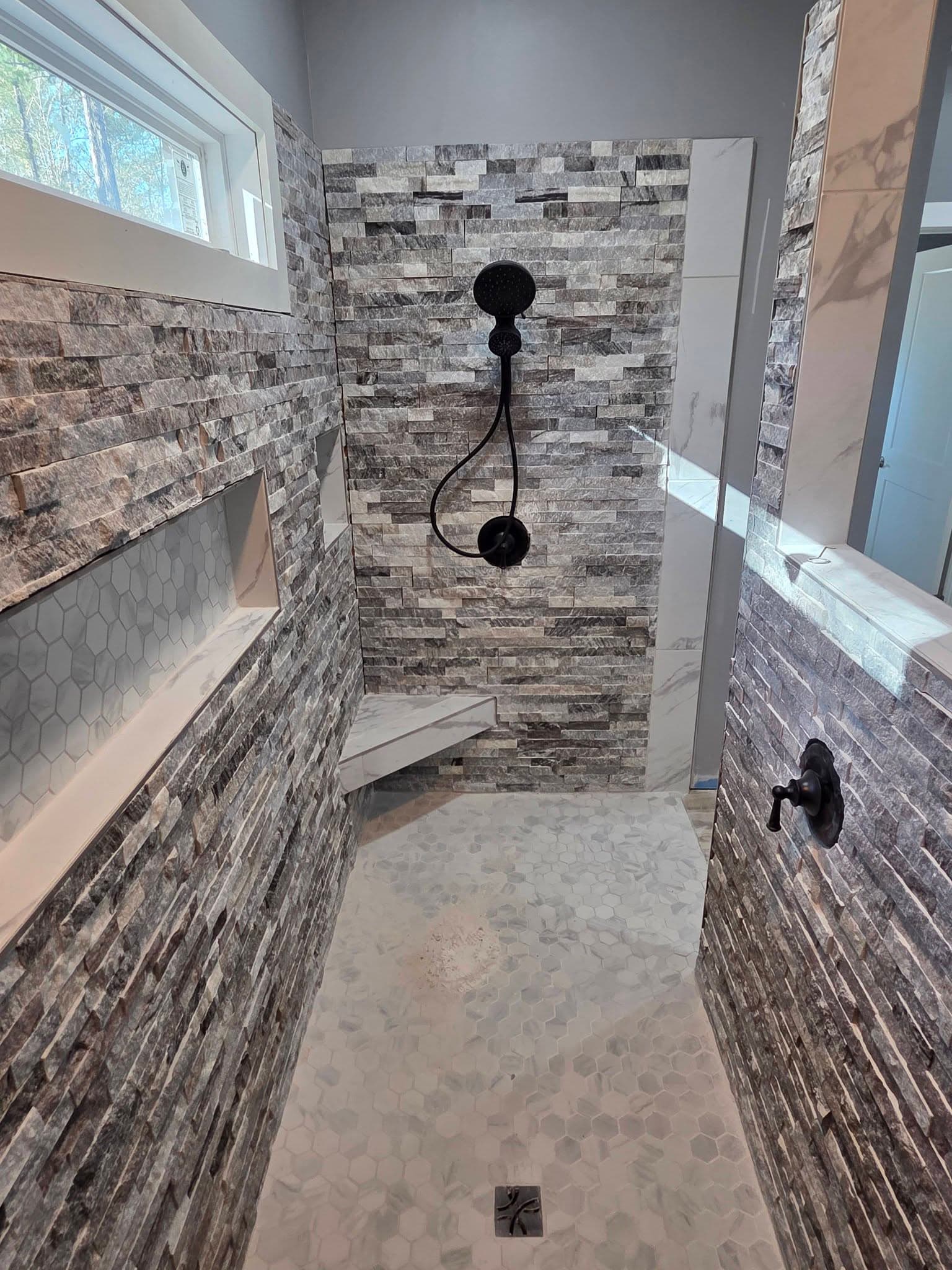 Custom shower tile build in progress by Burnette Flooring